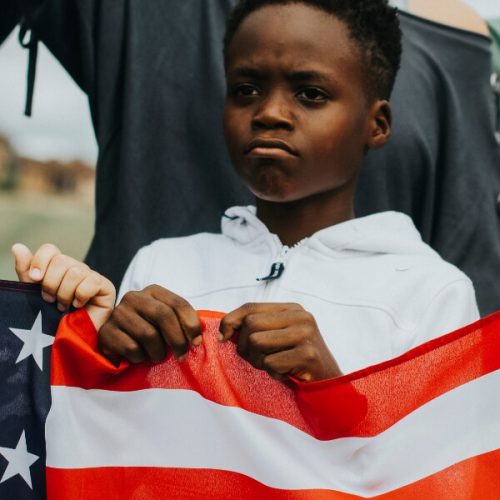 Child holding American flag