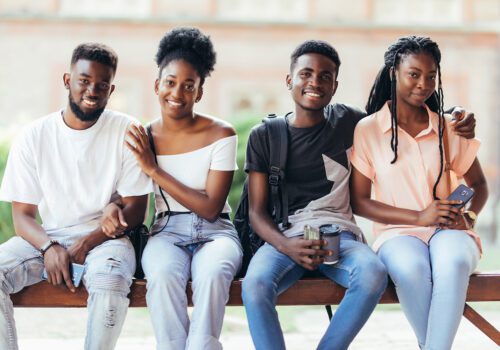 Group of youth sitting on bench